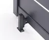 A close-up view of the bottom corner of a dark gray garden gate, showing a metal hinge mechanism and a mounting bracket. Produktbild-Vorschau