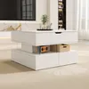 A modern white coffee table with a lift-top and storage, placed in a living room setting. Produktbild-Vorschau