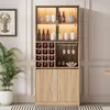 A tall, modern display cabinet with glass doors and wooden accents, filled with wine bottles, glasses, and decorative items. Náhled obrázku produktu
