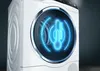 A close-up of a white washing machine with a glowing blue thermometer graphic inside the drum. Produktbild-Vorschau