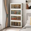 A white plastic storage cabinet with transparent doors, filled with various items, placed next to a window with curtains and a bed. Náhled obrázku produktu