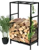 A black metal firewood rack filled with logs, with a potted plant and ivy on the side. Podgląd zdjęcia produktu