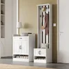 A hallway with a white shoe cabinet and a white coat rack with a hat and scarf. Produktbild-Vorschau