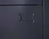 A close-up view of a dark gray metal locker with an embossed rectangular indentation, likely a handle or label holder. Produktbild-Vorschau
