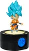 A Goku figurine is displayed on top of a black alarm clock with a digital display. Voir les images du produit