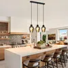 A modern kitchen island with pendant lights hanging above it. Produktbild-Vorschau