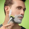 A man is shaving his face with a razor and shaving cream. Náhľad obrázku produktu