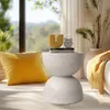 A stylish side table with decorative items in a bright, sunlit room. Podgląd zdjęcia produktu
