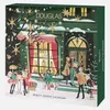 A Christmas-themed advent calendar box with illustrations of people shopping outside a store. Produktbild-Vorschau