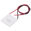 A square white thermoelectric generator module with red and black wires attached, lying on a white background. Podgląd zdjęcia produktu