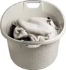 A laundry basket filled with clothes. Podgląd zdjęcia produktu