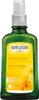A green glass bottle of Weleda Calendula massage oil with a yellow label. Anteprima dell’immagine prodotto