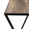 A close-up view of the corner of a wooden tabletop with a black metal frame. Anteprima dell’immagine prodotto