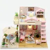 A miniature dollhouse with furniture and accessories, set against a white background. Podgląd zdjęcia produktu