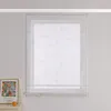 A window with a sheer curtain featuring a floral pattern, next to a framed picture and a candle on a dresser. Produktbild-Vorschau