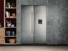 A modern kitchen with a side-by-side refrigerator and shelving unit. Náhled obrázku produktu