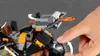 A hand is shown interacting with a LEGO toy, specifically turning a gear mechanism on a dragon-like vehicle. Produktbild-Vorschau