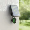 A solar-powered outdoor security camera mounted on a wall. Podgląd zdjęcia produktu