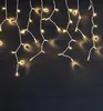 Icicle lights hanging against a dark wooden background. Náhled obrázku produktu