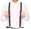 A person wearing a white shirt and black suspenders. Náhled obrázku produktu