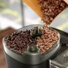 Coffee beans being poured into a coffee grinder. Produktbild-Vorschau