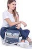 A woman is sitting on the floor with a blue handbag. Anteprima dell’immagine prodotto