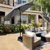 A patio scene with outdoor furniture and a large gray umbrella. Produktbild-Vorschau