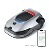 A silver robotic lawn mower is shown from a diagonal angle, with a smartphone displaying a map next to it. Logos for Alexa and Google Home are visible at the bottom. Produktbild-Vorschau