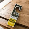 A humorous door hanger shaped like a piano keyboard is placed on a wooden table. Anteprima dell’immagine prodotto