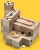 A wooden marble run construction set with four marbles (blue, red, yellow, and white) on a yellow background. Náhľad obrázku produktu