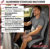 A man is sitting in a car seat with a grey seat cover on. Produktbild-Vorschau