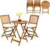 A wooden bistro set with two chairs and a table, set against a white background. The chairs have beige cushions, and the table has two cups and a vase with yellow flowers. Náhľad obrázku produktu