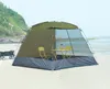 A screen tent set up on a beach with a table and chairs inside. Náhled obrázku produktu