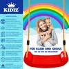 A mother and daughter are smiling on a swing set with a rainbow in the background. Produktbild-Vorschau