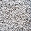 A close-up, overhead view of small, light-colored pebbles or granules. Produktbild-Vorschau