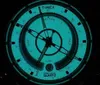 A close-up of a Timex watch face with a glowing blue dial. Podgląd zdjęcia produktu