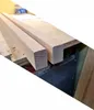 Two pieces of unfinished wooden lumber are laid on a workbench. Produktbild-Vorschau