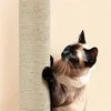 A Siamese cat is scratching a beige rope-covered scratching post. Produktbild-Vorschau