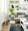 A modern living room scene with a sofa, coffee table, and plants. Produktbild-Vorschau