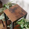A close-up view of a wooden plant stand with plants on it. Anteprima dell’immagine prodotto