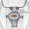 A close-up view of a baby bouncer's harness and buckle system, featuring a patterned fabric and a brand logo. Náhled obrázku produktu