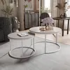 A living room scene with two nesting coffee tables, decorative items, and furniture. Voir les images du produit