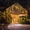 A house decorated with Christmas lights during a snowfall. Náhled obrázku produktu
