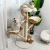 Two cats are playing on a multi-level cat tree with baskets and perches, in a brightly lit room with sheer curtains and a plant in the background. Produktbild-Vorschau