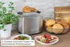 toastet Croissant auf Küchentheke mit Pflanze, Brötchen, Brett, Toast, Obst und Aufstrich. Anteprima dell’immagine prodotto