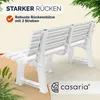 A white plastic garden bench shown from a rear-diagonal angle, with green foliage in the background and foreground. Text overlays highlight product features. Náhled obrázku produktu