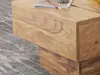 A close-up shot of a wooden coffee table with a book and pencil on top. Náhled obrázku produktu