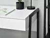 A close-up view of a white desk with a black metal frame, showing a drawer and a portion of the tabletop with a plant and a lamp. Anteprima dell’immagine prodotto