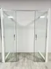 A shower enclosure with sliding glass doors, presented in a showroom or retail setting. Produktbild-Vorschau