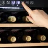 A hand is adjusting the temperature on a wine cooler filled with wine bottles. Produktbild-Vorschau